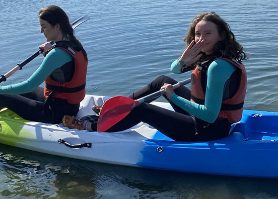 Two students are in a kayak