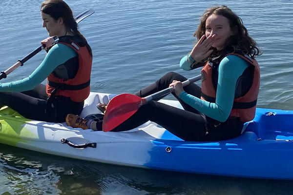 Two students are in a kayak