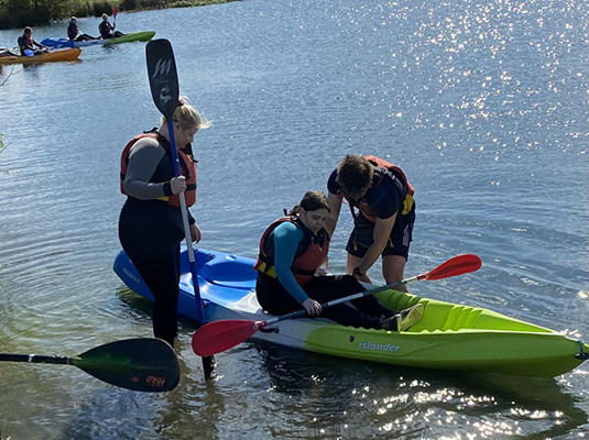 3 students are in a kayak