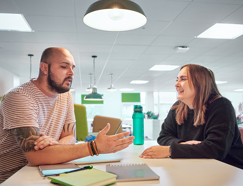 Two students talking and smiling