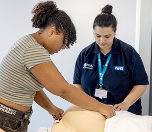 a student midwife working with a practitioner