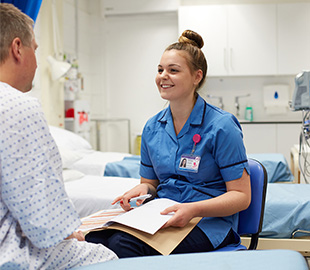 a student nurse in a practice room and assisting a patient