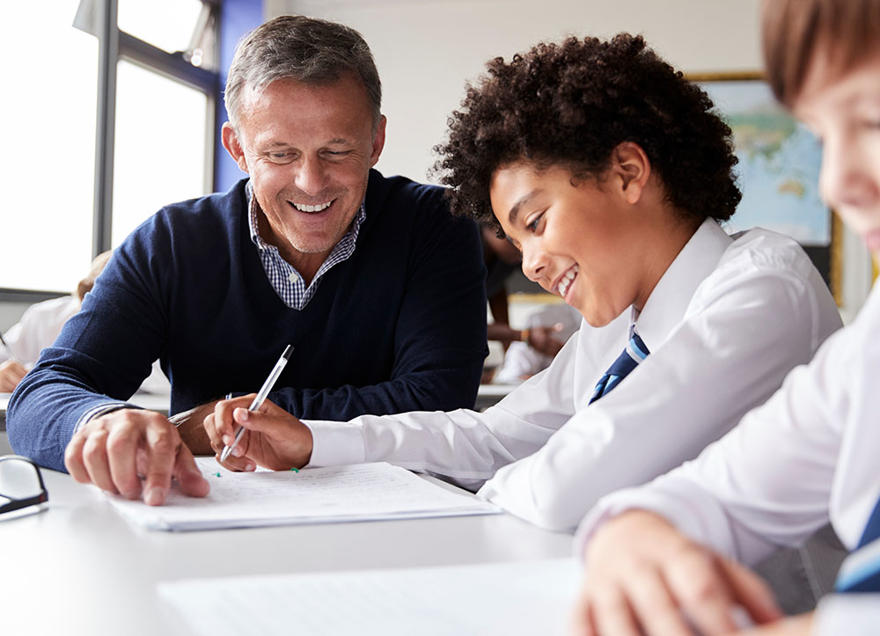 A teacher is helpinga student to study