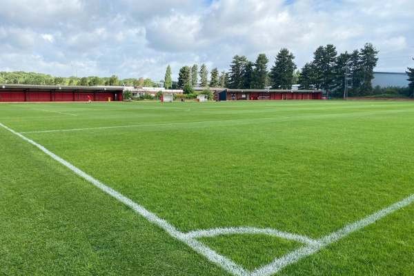 Corner of football pitch on partly cloudy day