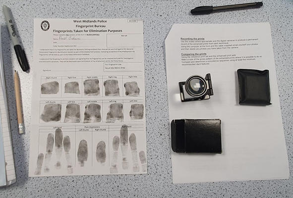 A sheet of finger prints is on a desk