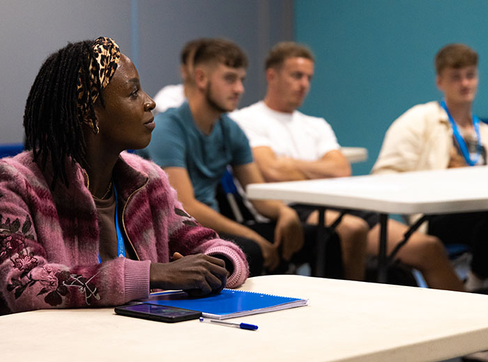 A group of students are listening attentively