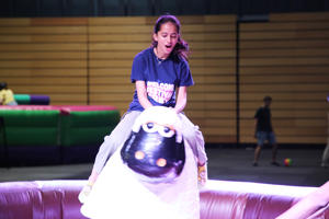A student on a mechanical bucking sheep