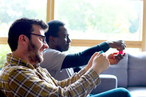 Two students playing a video game together