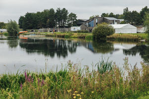 Lake in foreground with buildings on other side