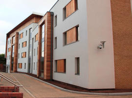 white accommodation buildings beside a road
