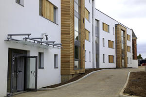 white and brown accommodation buildings alongside a road