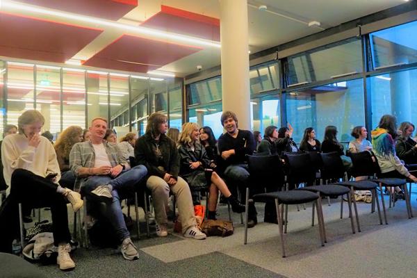 View of a room of students sat down talking