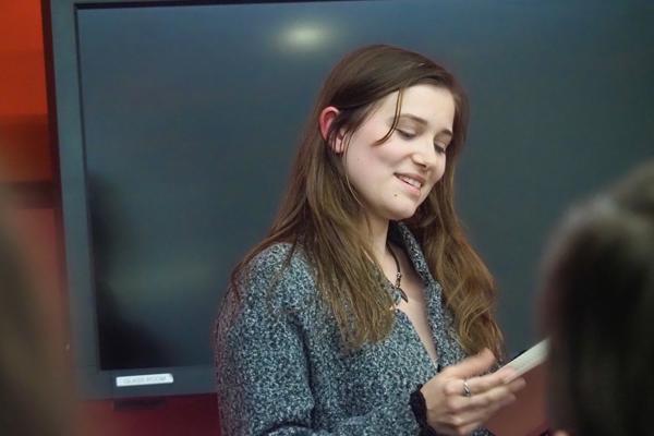 student reading from a book