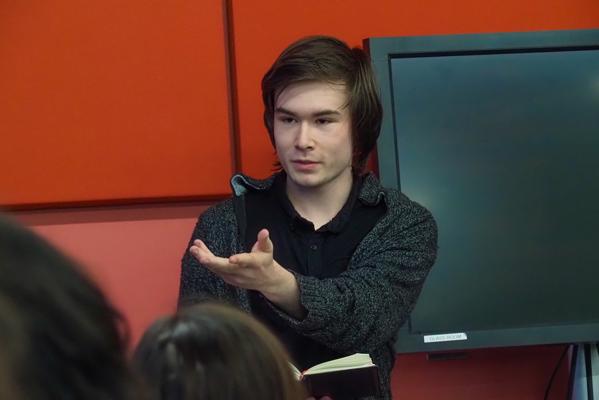 student holding out his hand to camera