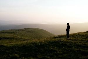 misty mountain view with man in silhouette