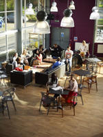elevated view of students sitting in the communal area in the hangar