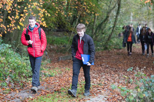 two students walking along a forest path