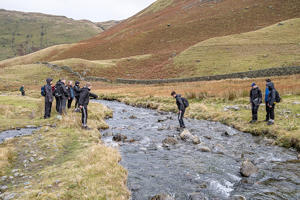 students either side of a river