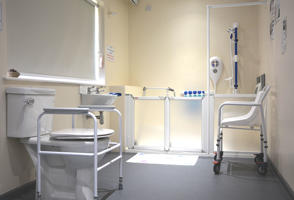 inside a bathroom with supportive equipment to assist the less able-bodied