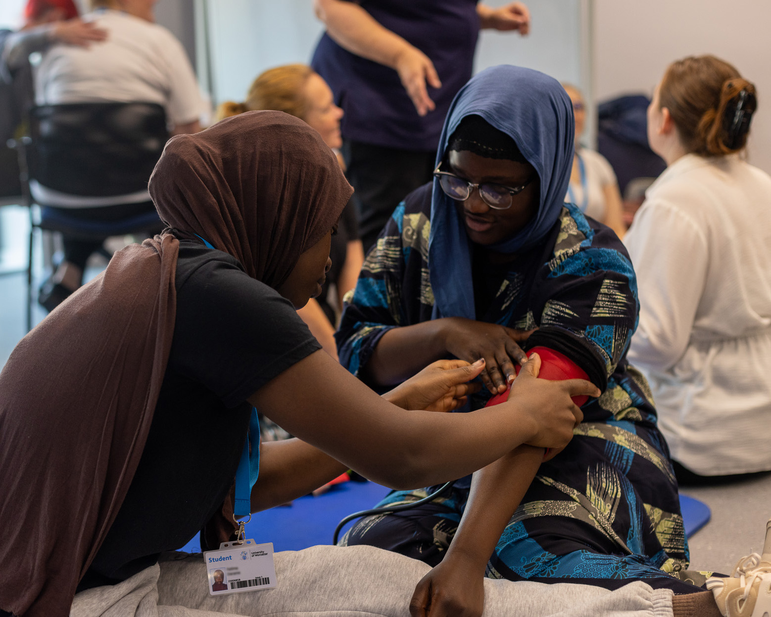 Midwifery students practicing taking blood pressure