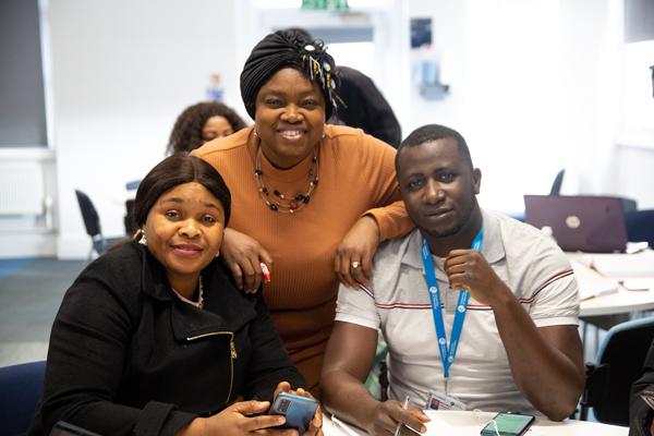 three students looking towards the camera