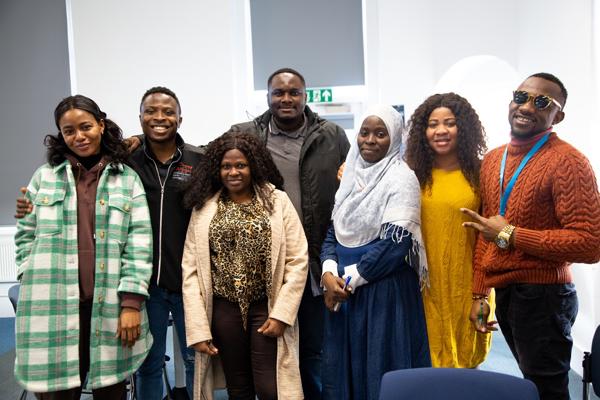 group of students standing in a line smiling at camera