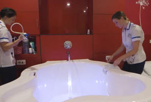 two students beside a birthing pool