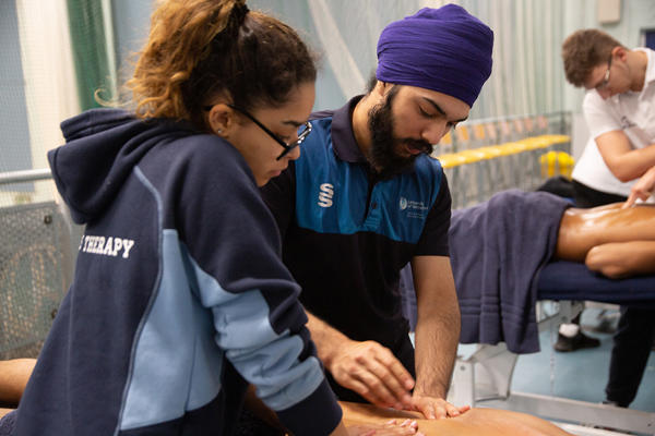 Two Sports Therapy degree students at a clinic