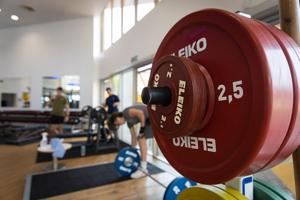 red dumbbell on the right hand side of a gym