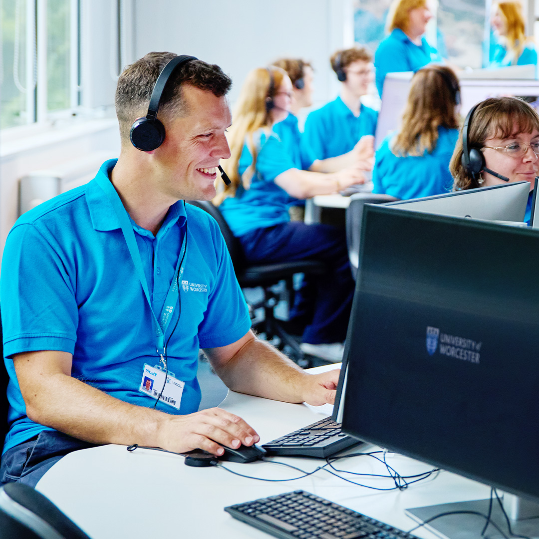 A busy call centre with staff with headsets smiling