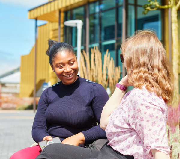 Two students outside the EGA building