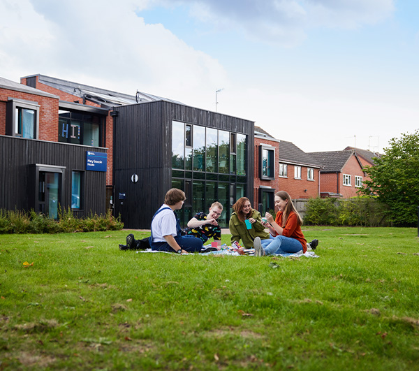 A group of students enjoying a picnic outside of student accommodation
