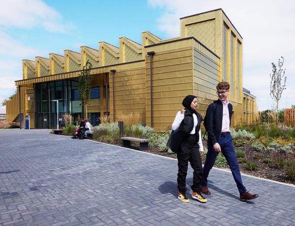Two students walking outside the EGA building