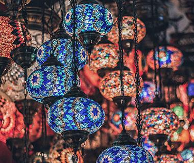 A close up shot of colourful middle eastern lanterns twinkling at a marketplace