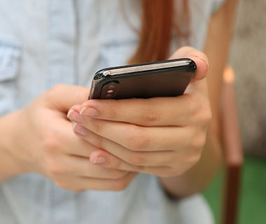 a person's hand holding a mobile phone