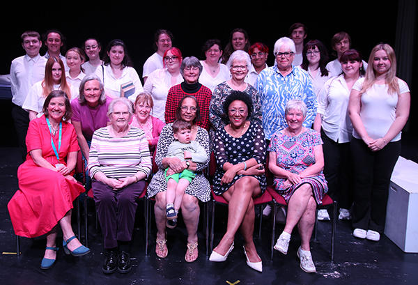 A large group of people looking at the camera, consisting of Theatre and Performance students with members of Worcester Royal Infirmary Nurses League.