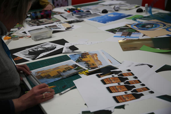 Images of Worcester-related items, including Worcestershire Sauce and The Hive, laid out on a table with a student looking at them