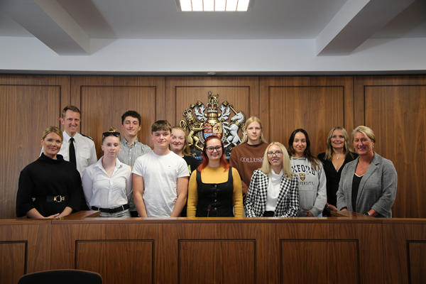 Professional Policing degree launch, students and relevant staff members stood at the front of a Law court
