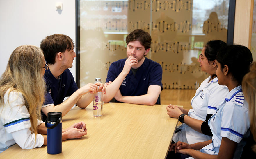 Students from various healthcare disciplines having a discussion