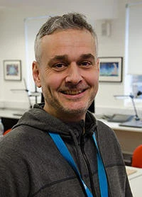 University of Worcester logo on a light blue background