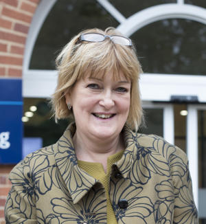 Jo Smith stood outside University of Worcester main reception, smiling at camera