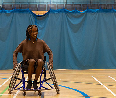 a lady is playing wheelchair basketball