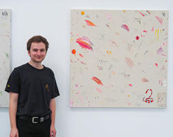 Cameron Bryan standing next to his work