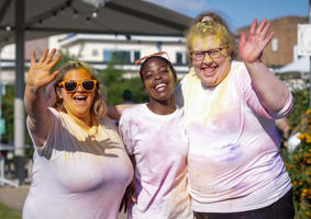 students in t shirts covered in coloured paint at the colour run