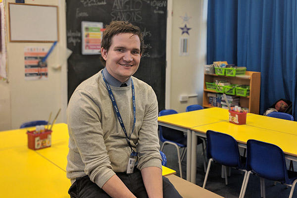 Alex Holloway sitting on a table