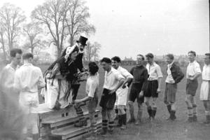 Several men lining up in P.E. kit