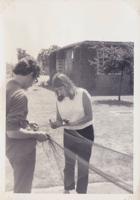 Two people holding a net in the 1960s