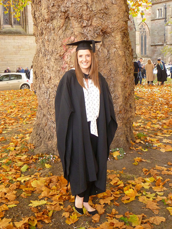 Angela Sturgess in her graduation robes outside the Cathedral