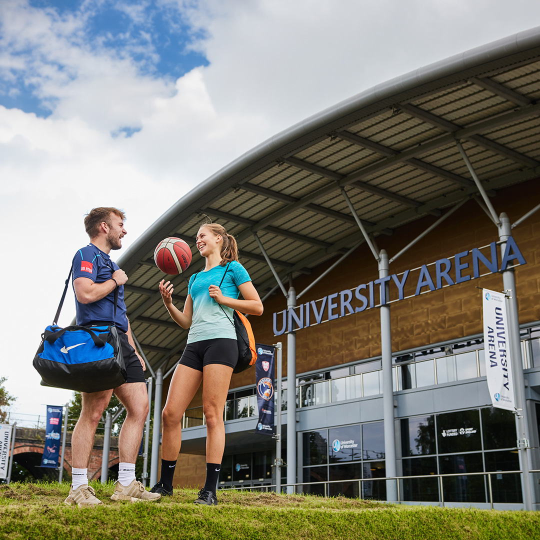two sport students outside an arena