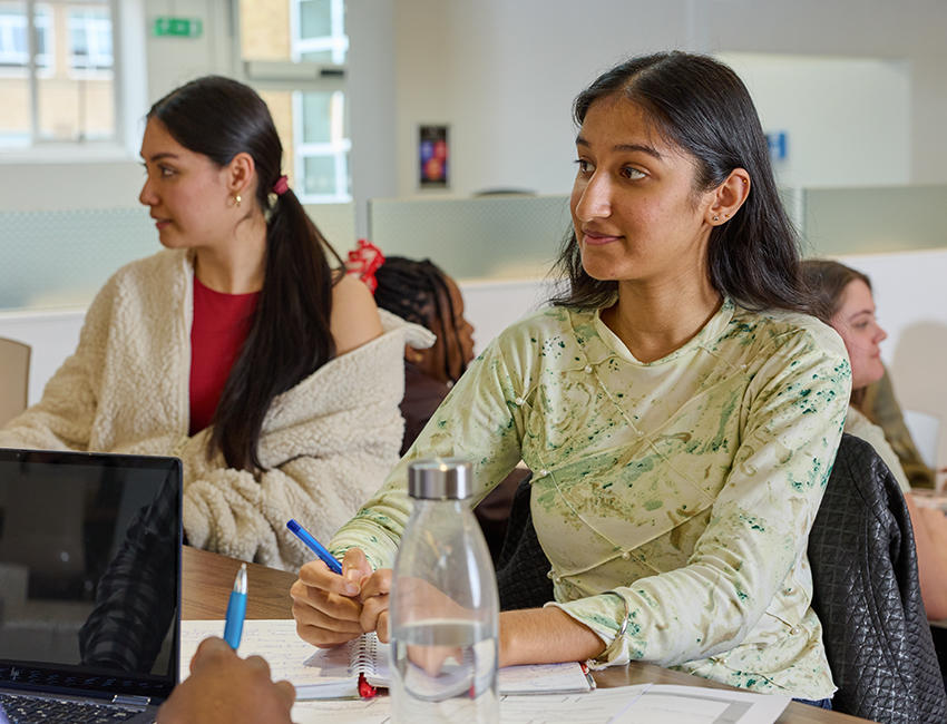 two students working in the university canteen